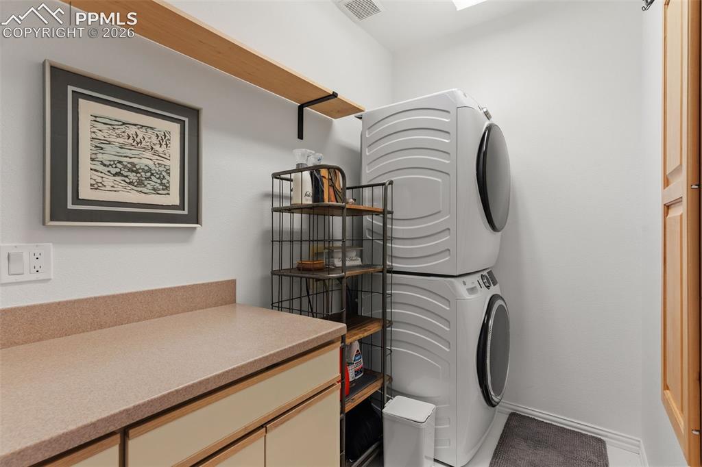 Image 25 of 49: Main level laundry with extra capacity GE Washer & Dryer that stay