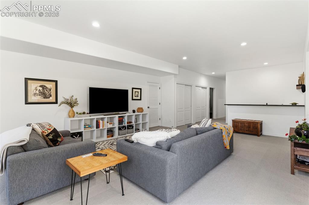 Image 28 of 49: Spacious rec room with a wet bar - loads of closet and storage space in thi