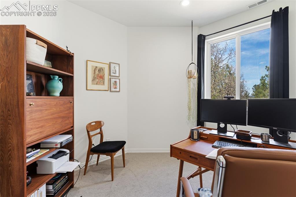 Image 31 of 49: Perfect peaceful basement office with calming outdoor view!