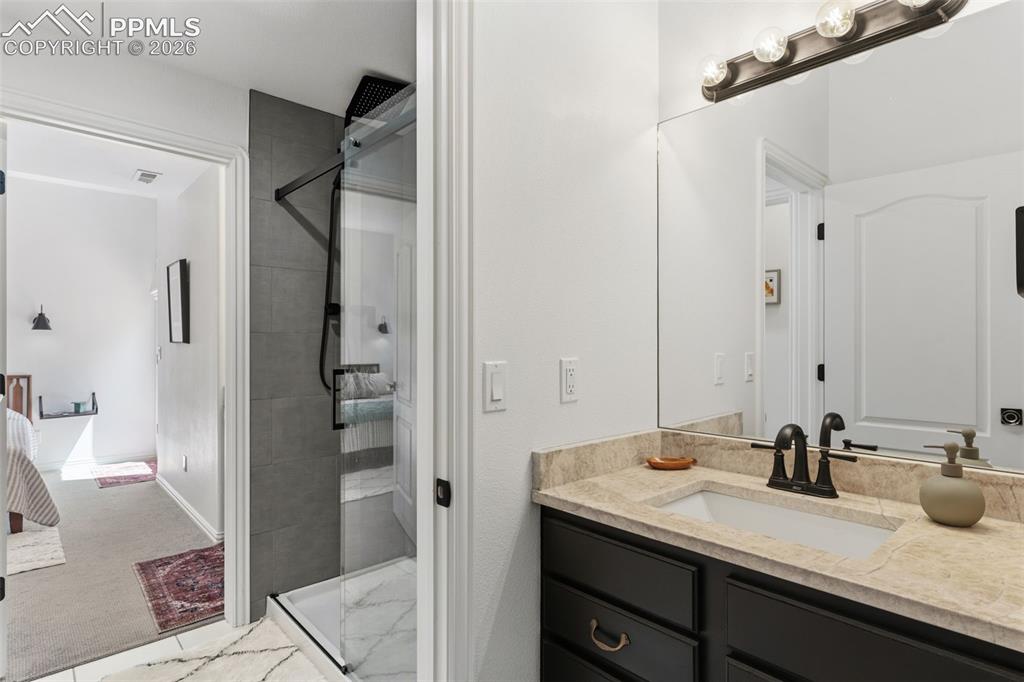 Image 33 of 49: Separate sinks for each basement bedroom with a Jack & Jill shared shower &