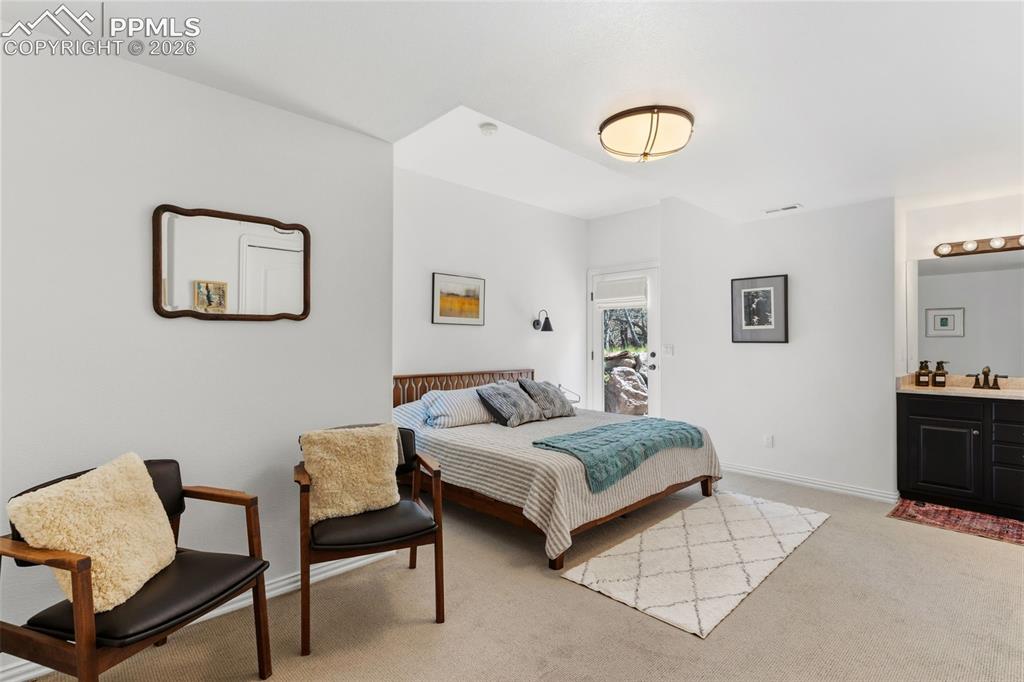 Image 35 of 49: Large basement bedroom with a walk-out, separate sink/vanity & a shared Jac