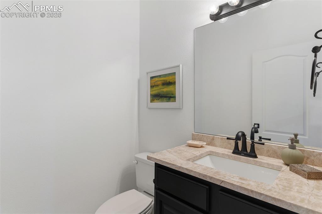 Image 37 of 49: Basement 1/4 Bath with Taj Majal quartzite countertop