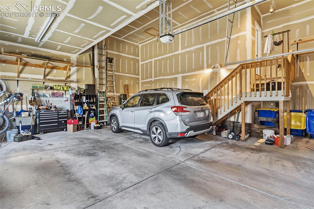 Image 39 of 49: Oversized garage with HIGH ceilings!