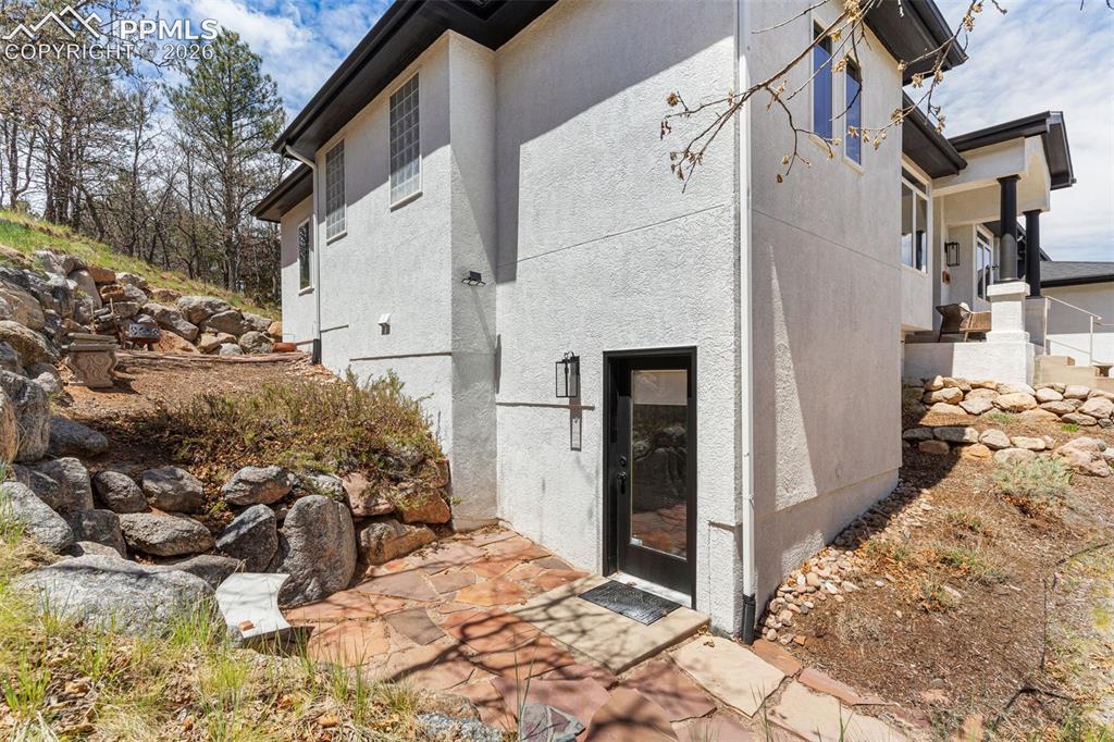 Image 43 of 49: Walk out & small patio area for the basement bedroom