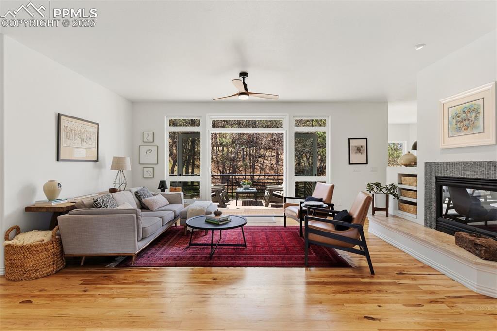 Image 7 of 49: Open & bright living room w/ hickory floors, french doors that open to the 
