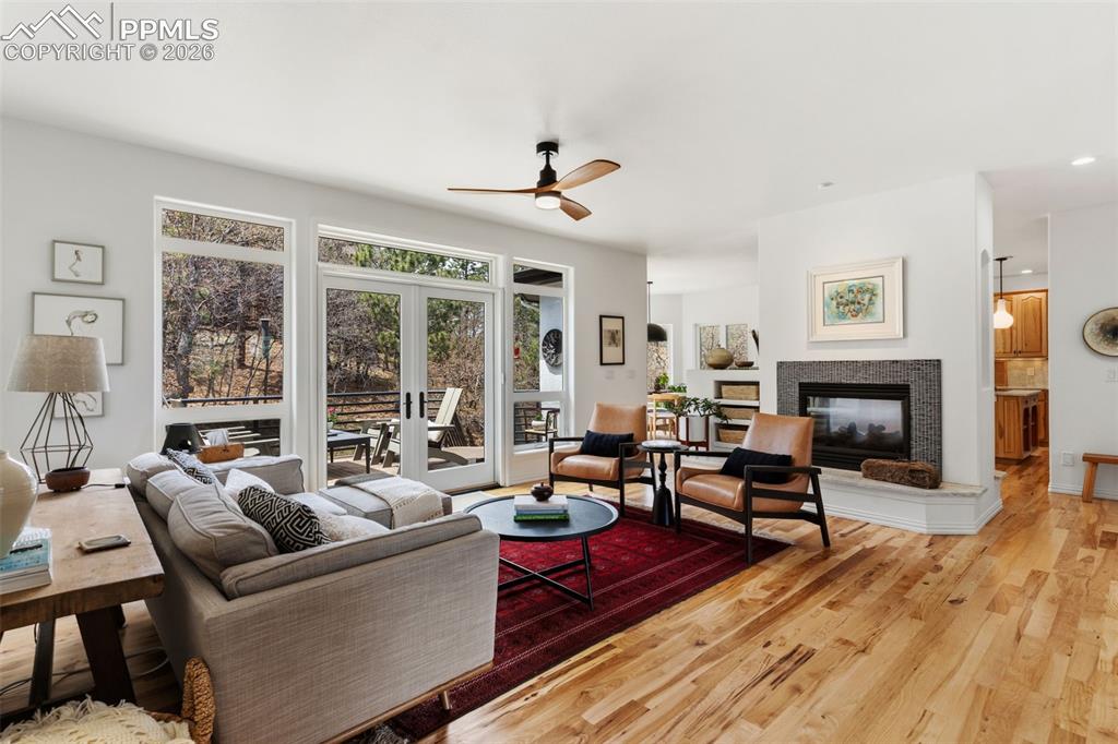 Image 8 of 49: Beautiful space with hickory floors, French doors, & double sided fireplace