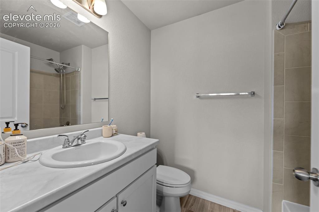 Image 14 of 32: Vanity with integrated sink, chrome faucet, and white cabinetry