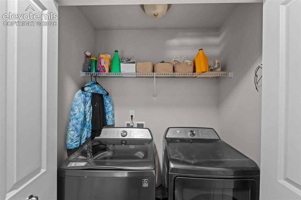 Image 15 of 32: Dedicated laundry area with a wire storage shelf