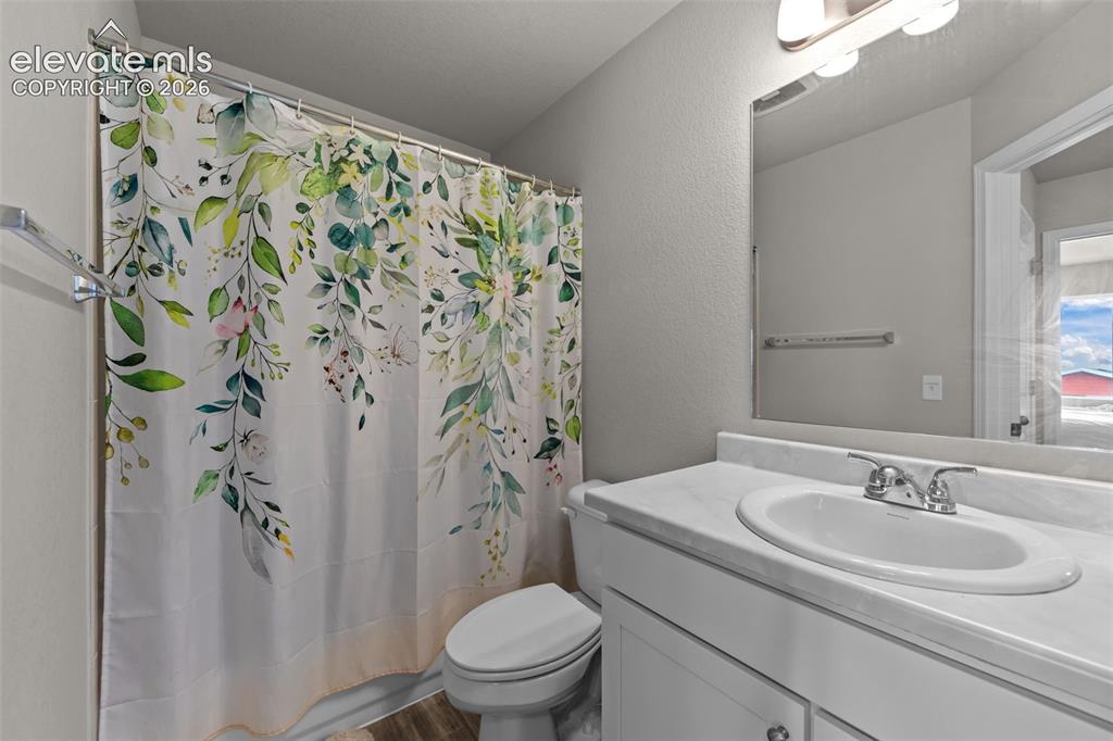 Image 18 of 32: Bathroom with a single vanity, undermount sink, and wall-mounted mirror