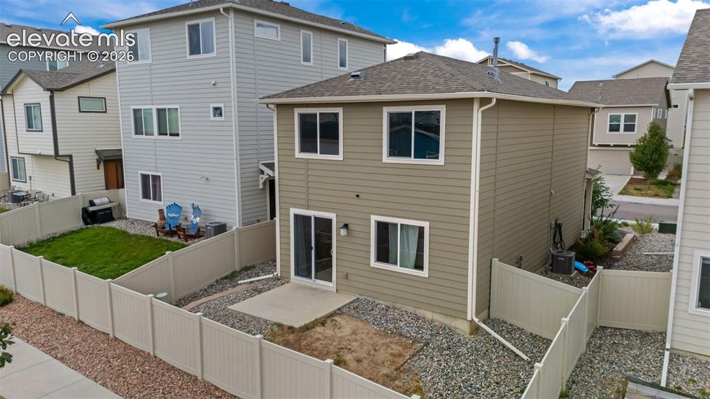 Image 20 of 32: Rear exterior featuring horizontal siding, multiple windows, a sliding glas