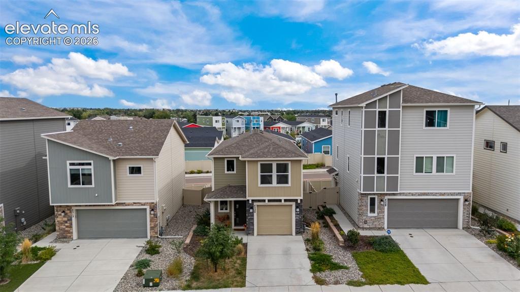 Image 22 of 32: Modern architectural design featuring varied siding materials, attached gar
