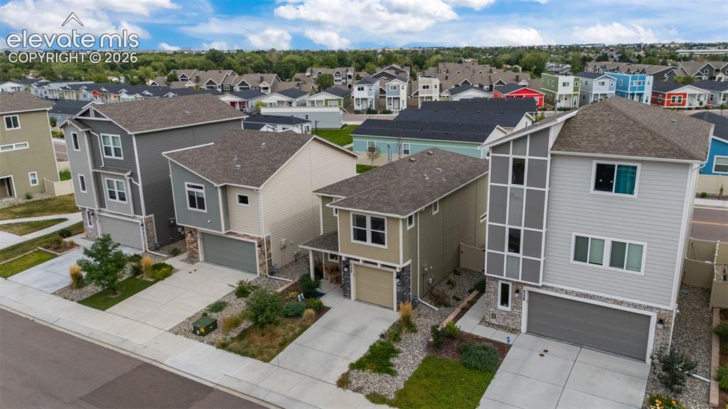 Image 23 of 32: Modern architectural design featuring multi-story residences with attached 