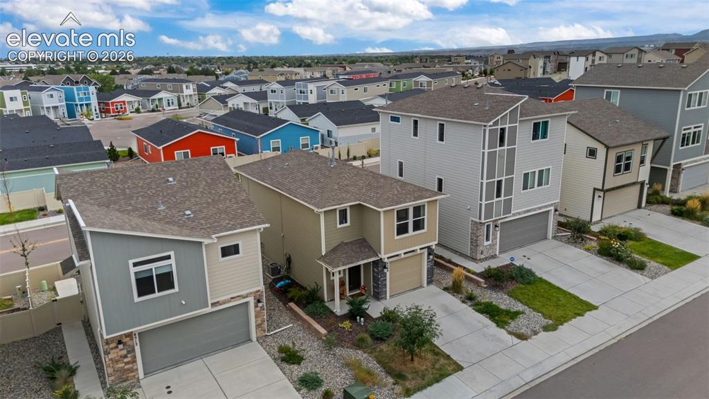Image 24 of 32: Contemporary architecture featuring multi-story designs, attached garages,