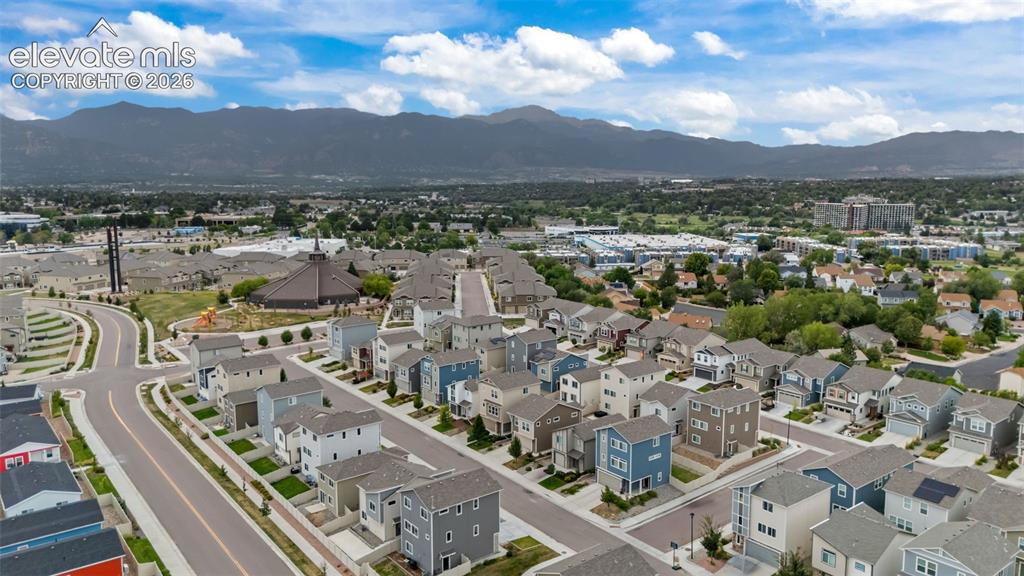 Image 29 of 32: New construction residences within a developed community featuring mountain
