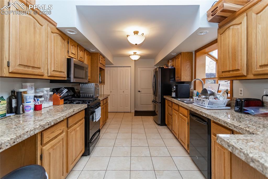 Image 16 of 45: Spacious kitchen with stainless steel appliances (including gas stove), rai
