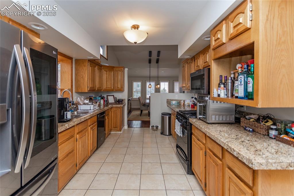 Image 19 of 45: The workhorse, efficient kitchen flows into the dining room & the living ro