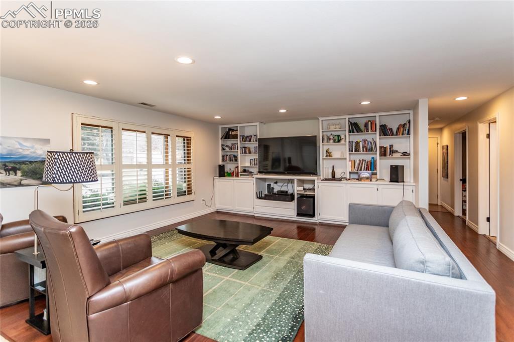 Image 31 of 45: Large, inviting, bright family room with plenty of built-ins for electronic