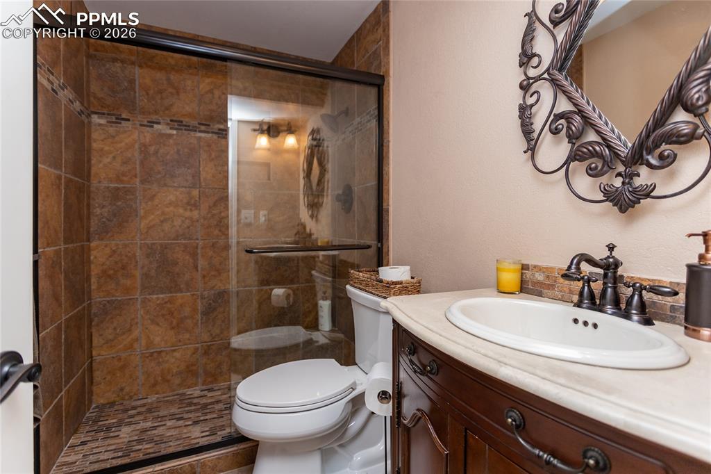 Image 34 of 45: The 3/4 bathroom downstairs has recently been updated with beautiful tile &