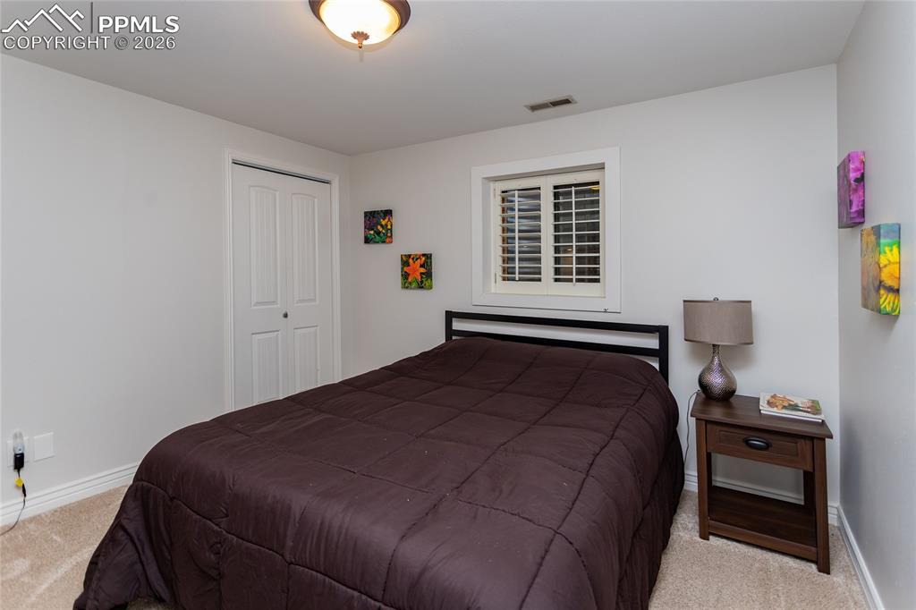 Image 35 of 45: Spacious, comfortable downstairs bedroom for family or guests.