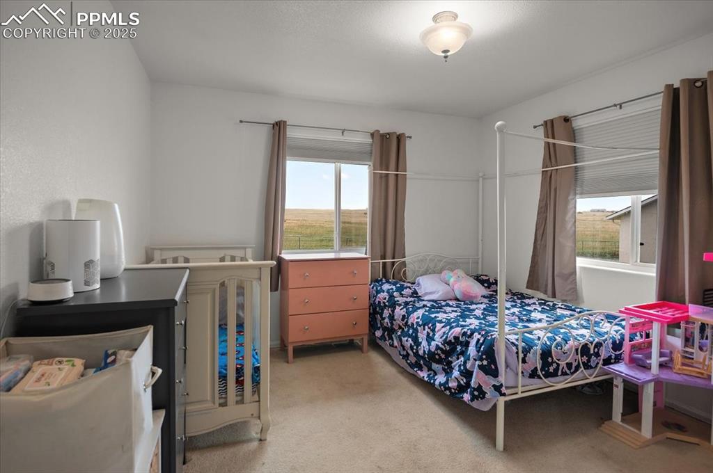 Image 17 of 38: Bedroom featuring light colored carpet