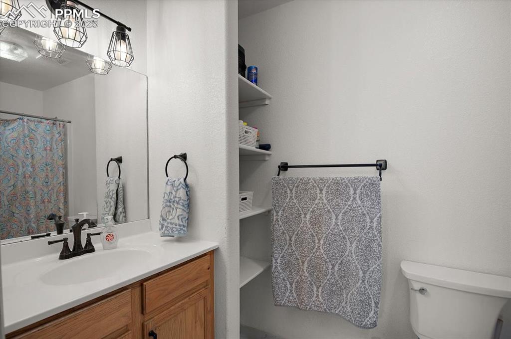 Image 18 of 38: Full bathroom with vanity and toilet