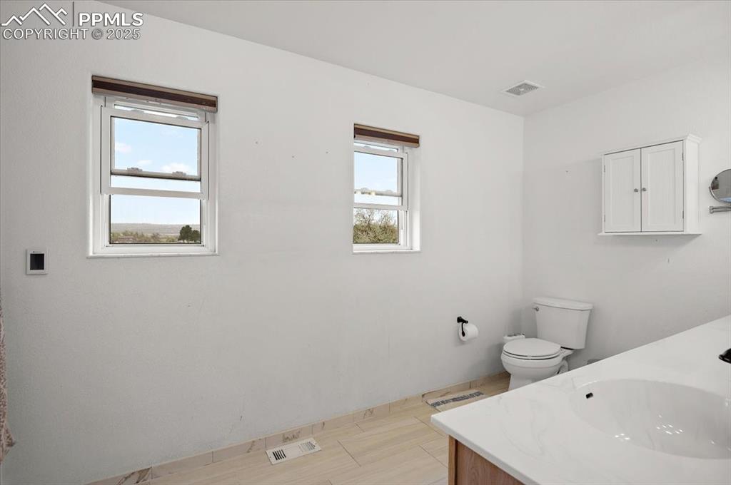 Image 22 of 38: Bathroom with vanity and toilet