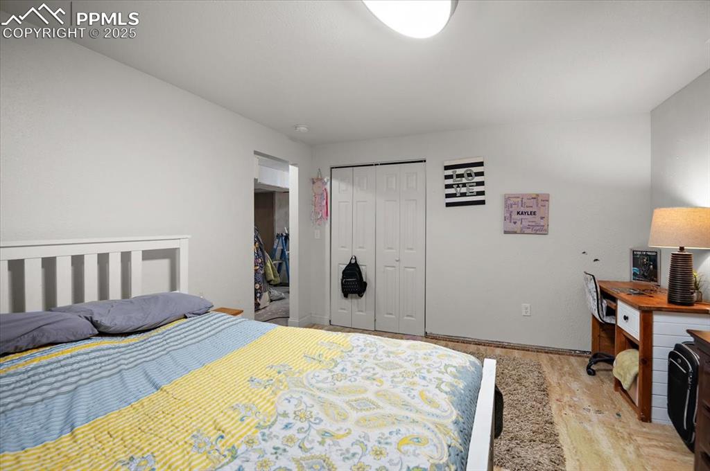 Image 27 of 38: Bedroom with light wood-type flooring, a closet, and baseboards