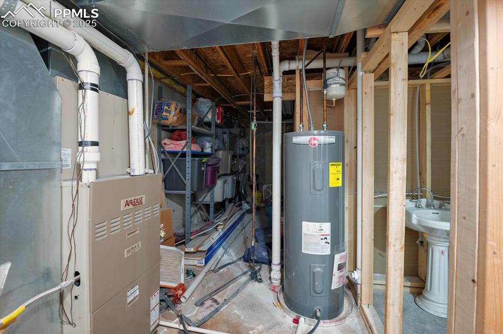 Image 30 of 38: Utility room with water heater