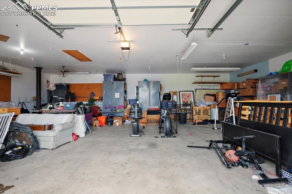 Image 35 of 38: Garage featuring a garage door opener