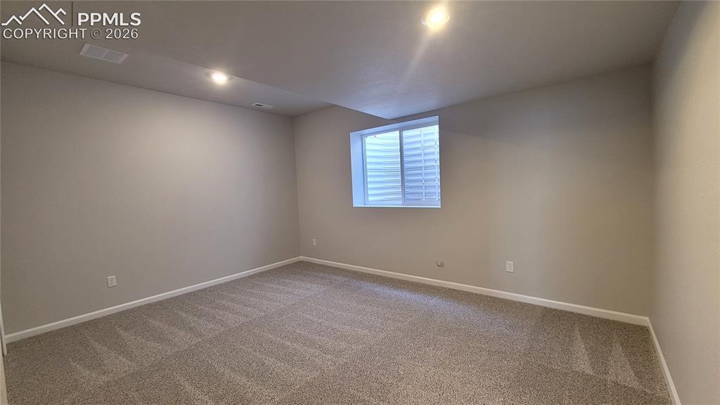 Image 26 of 33: 3rd Bedroom, with built-in shelving, located in the lower level! 