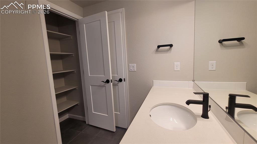Image 29 of 33: Full Bathroom with a linen closet, quartz countertops, and tile surrounds!
