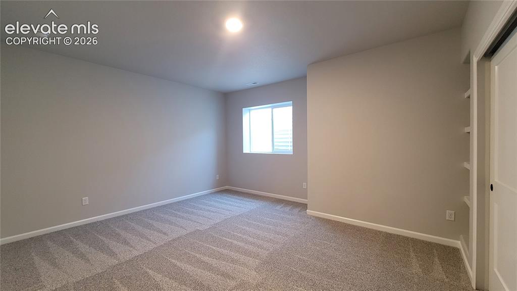 Image 39 of 50: 3rd Bedroom, with built-in shelving, located in the lower level!