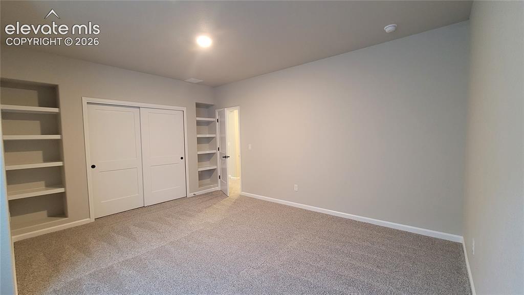 Image 40 of 50: 3rd Bedroom, with built-in shelving, located in the lower level!