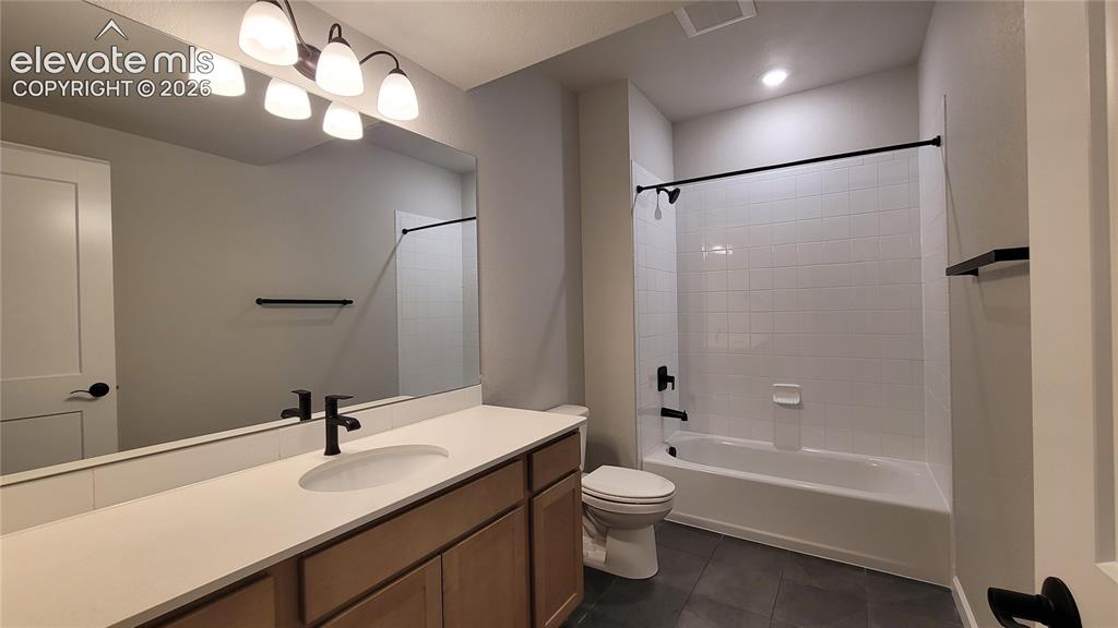 Image 43 of 50: Full Bathroom with a linen closet, quartz countertops, and tile surrounds!