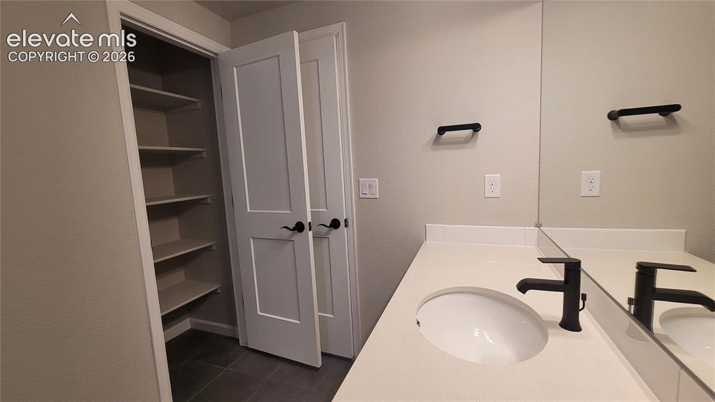 Image 44 of 50: Full Bathroom with a linen closet, quartz countertops, and tile surrounds!