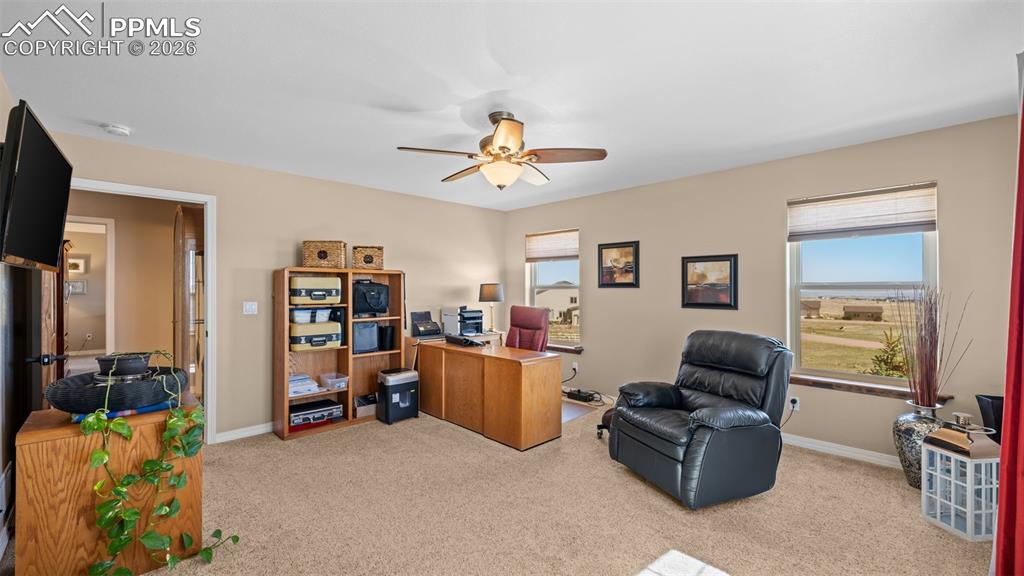 Image 27 of 47: Bedroom, currently used as an office, healthy amount of natural light, and 