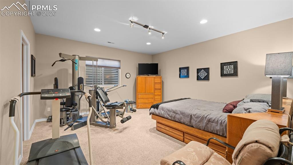 Image 41 of 50: Bedroom currently set up as a home gym
