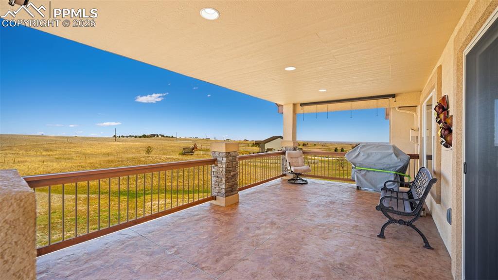 Image 5 of 47: View of low maintenance, stamped concrete covered deck with a view of count
