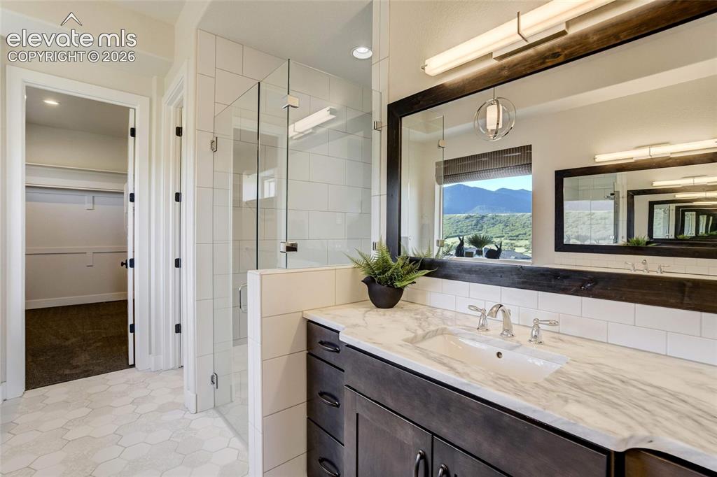Image 28 of 50: Owner Bathroom with separate sinks and walk-in shower