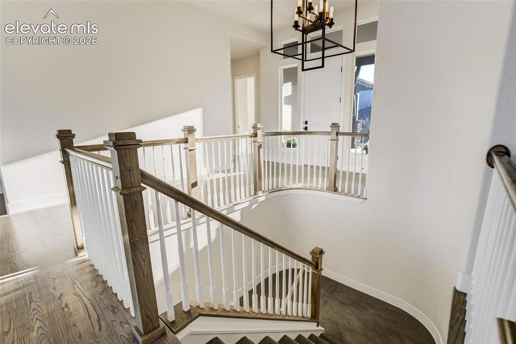 Image 38 of 50: Beautiful entryway leading to open staircase