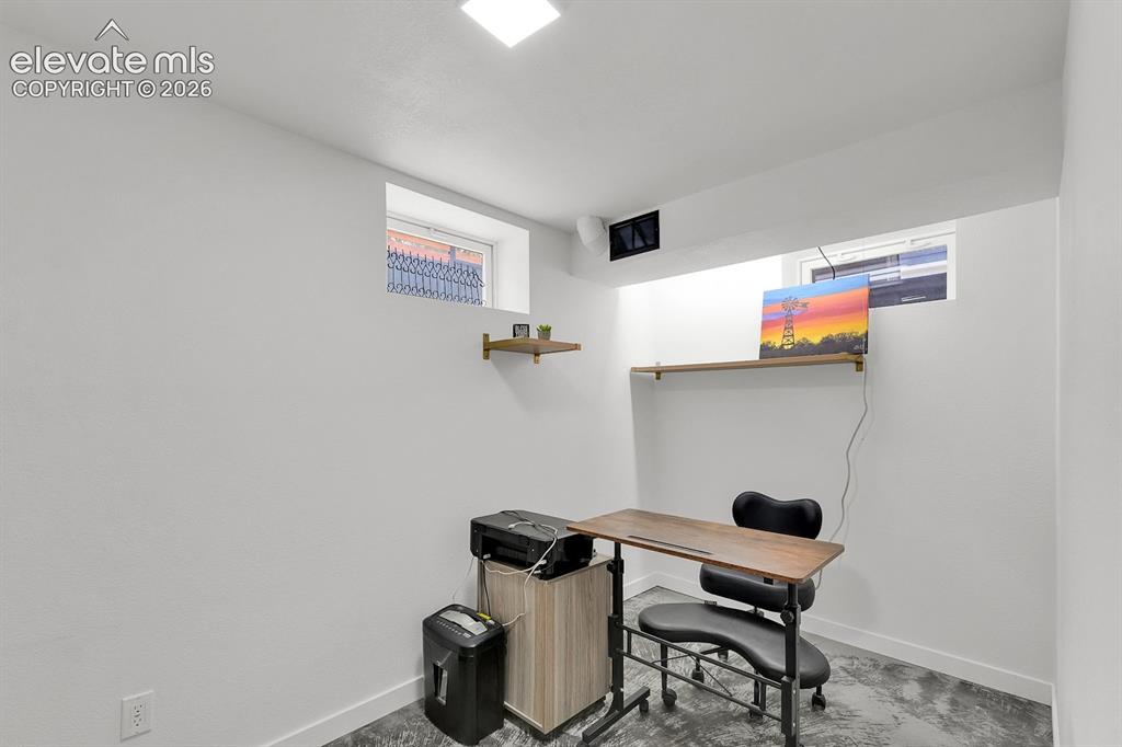Image 20 of 33: Versatile room featuring clean white walls and a concrete-finish floor