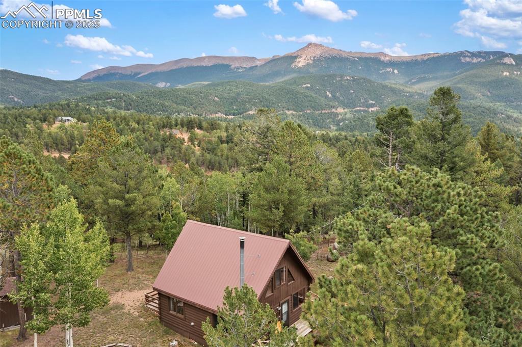 Image 2 of 45: Aerial view of property and surrounding area with a mountain backdrop