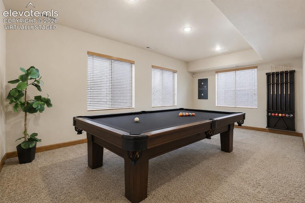 Image 27 of 33: Plenty of room for a pool table! Virtually staged.