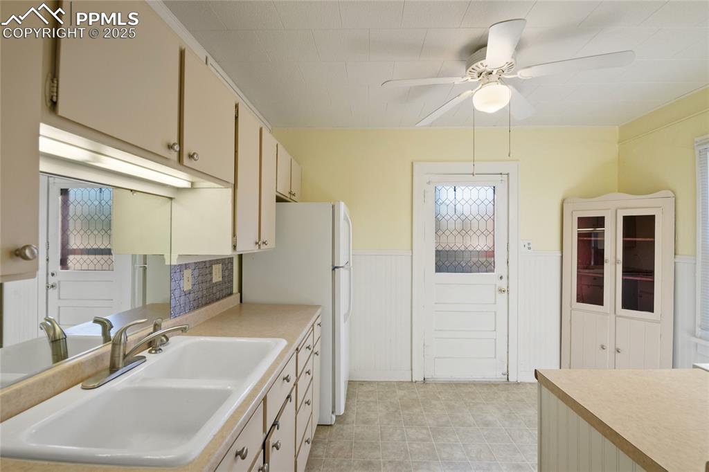 Image 16 of 28: Kitchen with freestanding refrigerator, and ceiling fan