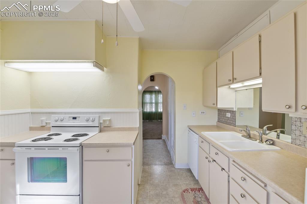 Image 17 of 28: Kitchen with freestanding refrigerator, and ceiling fan