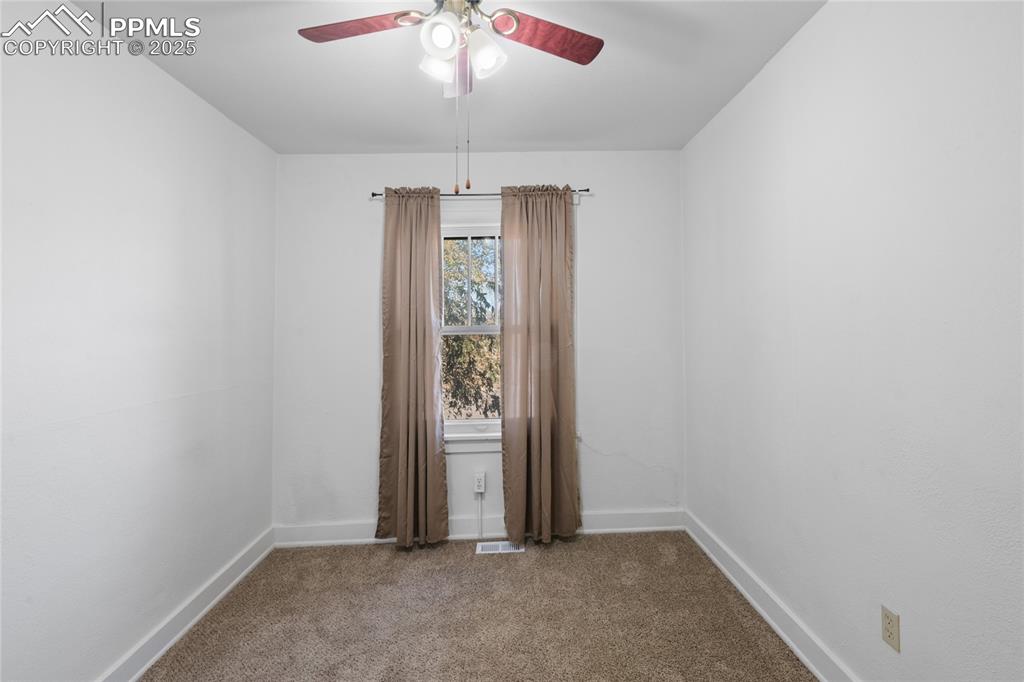 Image 19 of 28: Carpeted spare room with baseboards and a ceiling fan