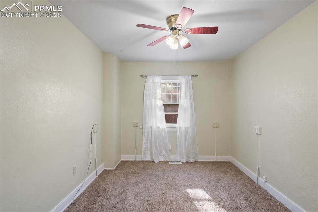 Image 23 of 28: Unfurnished room with light carpet and a ceiling fan