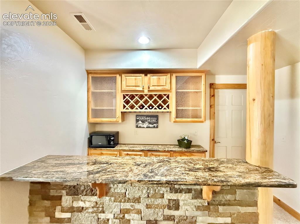Image 25 of 35: Basement bar for entertaining.