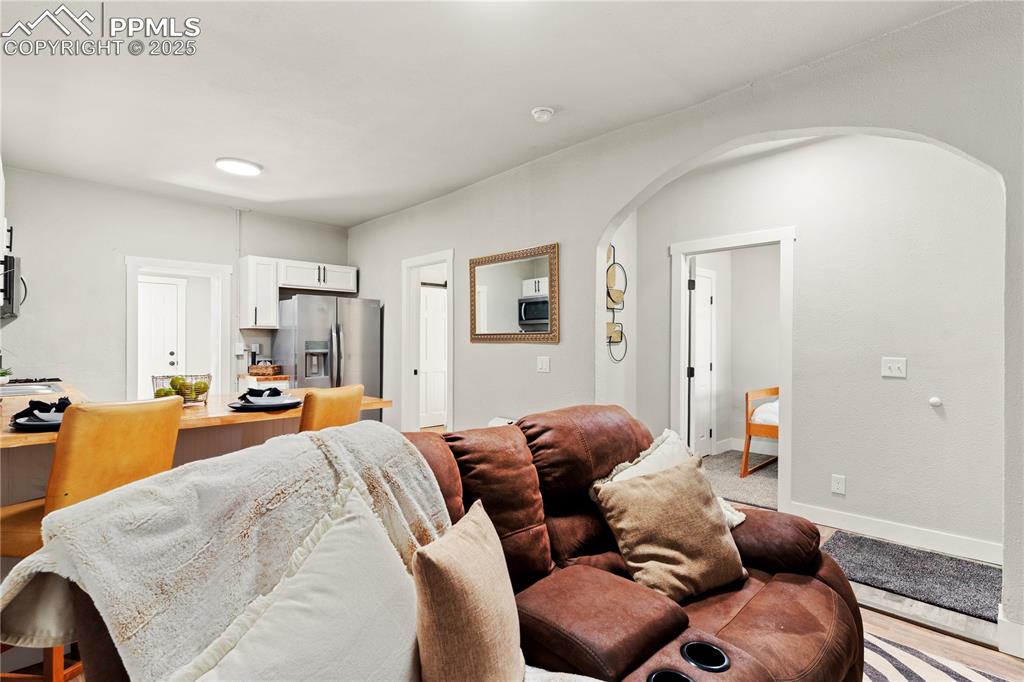 Image 3 of 13: Living area with arched walkways and baseboards