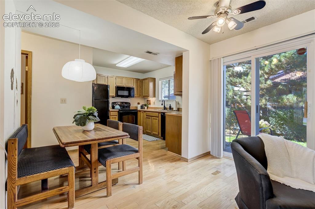 Image 10 of 50: Light wood-finish flooring, sliding glass door, recessed lighting, ceiling 